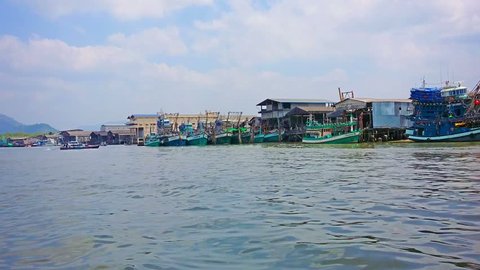 RANONG. THAILAND - CIRCA MAR 2014: Several fishing wooden ships are near the base