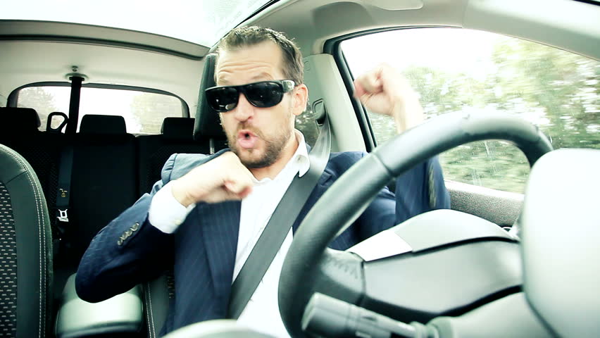 Succesful business man driving car making crazy moves celebrating deal