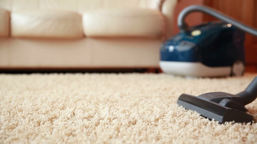 Vacuum cleaner cleaning the carpet, dolly shot. | Shutterstock HD Video #7078657