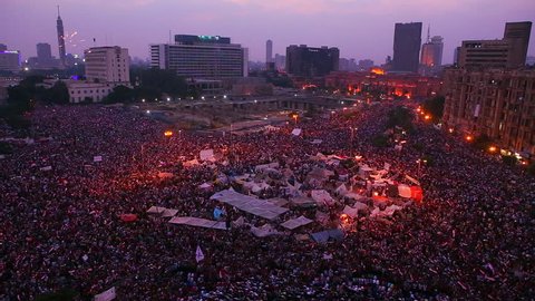 Fireworks go off above protestors gathered in Tahrir Square in Cairo, Egypt as dawn breaks.