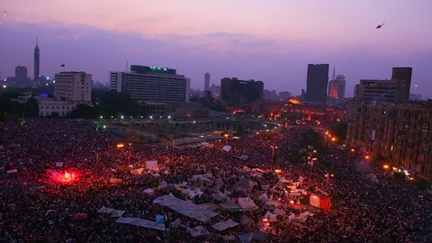 Fireworks go off above protestors gathered in Tahrir Square in Cairo, Egypt as dawn breaks.