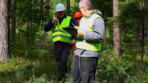 Forest Officer with two workers and documentation