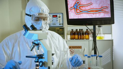 virologist looking at a sample in the microscope