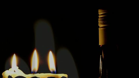 Three candles with bottle of champagne- slides prezentation