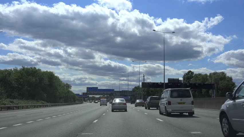M25 LONDON, HEATHROW, ENGLAND - AUGUST 2014 - POV Driving Shot of congestion on M25 Motorway - Bright Day With Blue Sky Clouds -  02666698  Royalty-Free Stock Footage #7090414