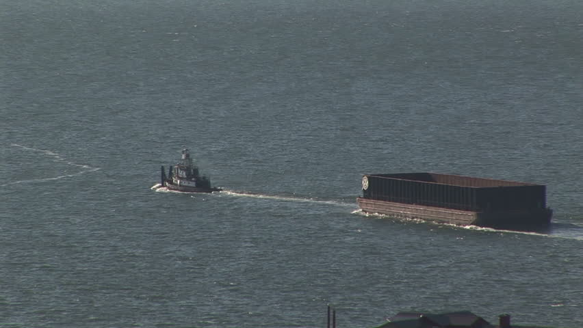Tugboat towing container barge