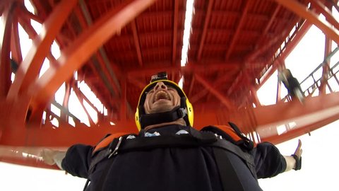 Close-up of a base jumper opening his parachute after jumping from a platform