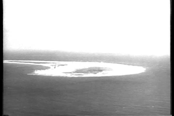 CIRCA 1950s - Men at Bikini Atoll watch a hydrogen bomb explosion over the Pacific Ocean in 1956.