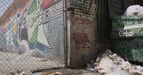 Slider Shot of Overflowing Trash Dumpster (ULTRA HD, UHD, 4K). Beautiful Destruction Represented By The Combination of Street Art and Street Trash. Shot On RED