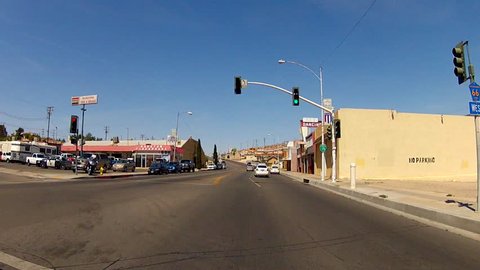 BARSTOW, CA: July 21, 2014- Point of view POV vehicle shot of a car driving on Route 66 circa 2014 in Barstow, California. A traveler drives past hotels on an iconic and historic roadway.