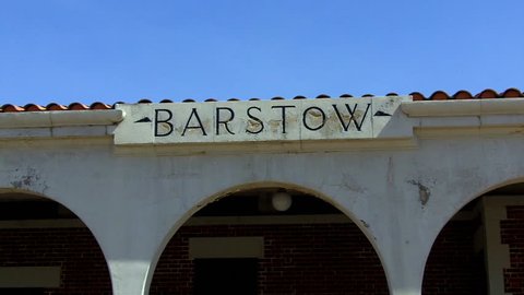 BARSTOW, CA: May 28, 2014- Shot of a Barstow sign on a historic train depot circa 2014 in Barstow. This clip features a view of a city name inscribed on a sign on a Southwest style building.