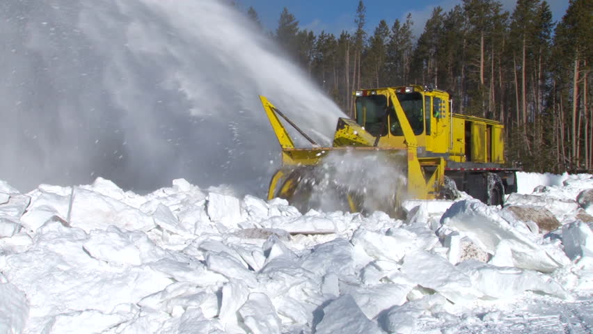 CIRCA 2010s - Snowplows clear roads in Yellowstone National park.