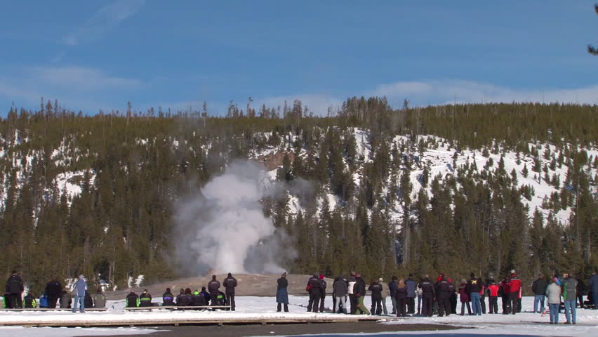 CIRCA 2010s - Old Faithful erupts in winter in Yellowstone National park.