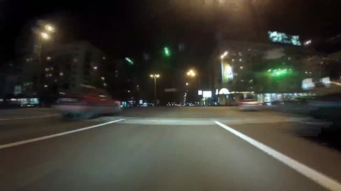 A vehicle racing down a street, passes by various cars, POV, time-lapse