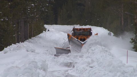 CIRCA 2010s - Snowplows clear roads in Yellowstone National park.