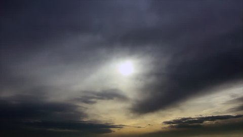 Dark grey clouds sky sun's disk silhouette