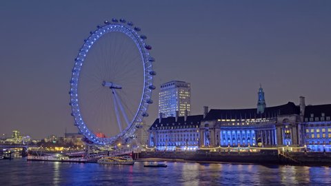 Static, time-lapse of the London Eye from across the river Thames at night.