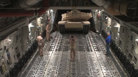 CIRCA 2010s - Airmen prepare secure and transport a USMC M1A1 Abrams tank to Afghanistan aboard a C-17 Globemaster.
