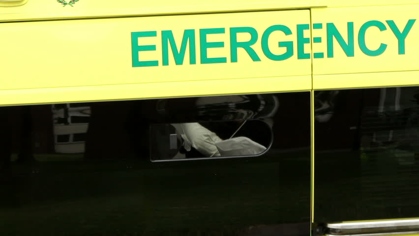 Look inside the ambulance through the open window -UK. Watching nurse preparations for treatment. Royalty-Free Stock Footage #7126963