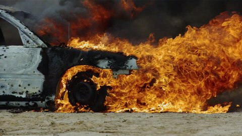 Pan around car on fire.