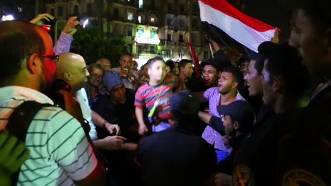 CAIRO, EGYPT - CIRCA 2013 - A protestor is hoisted on the shoulders of others during a night demonstration in Cairo, Egypt.