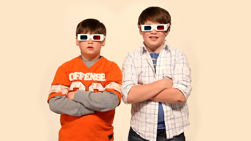 Two young boys wear 3D glasses.