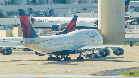 ATLANTA - 2014: Delta Airlines Boeing 747-400 Taxiing towards the New International Terminal at a Busy Hartsfield-Jackson Atlanta International Airport.