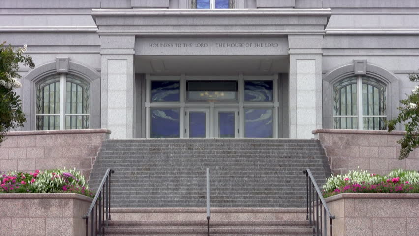 Video of San Antonio Texas Temple of Church of Jesus Christ of Latter-Day Saints, Mormon or LDS. Entrance with steps, water fountain with trees in front. Gold statue of Angel Moroni on steeple. 