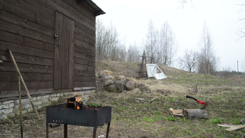 Man brings firewood from birch and kindles a fire in a brazier. Shooting on Nikon D800. Full HD video.