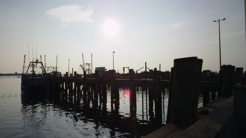sunrise over fishing boats in a harbor on Cape Cod