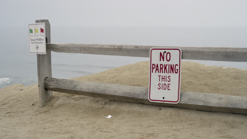 cape cod beach with sand and surd and beach sign
