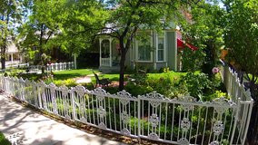 PRESCOTT, AZ: July 28, 2014- Shot of a home with porch and front yard flower garden circa 2014 in Prescott. This clip provides for an image of an idyllic and picturesque home in a quiet neighborhood. 