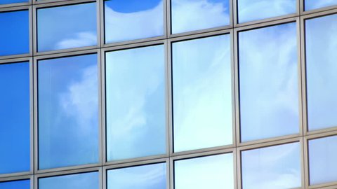 Timelapse of clouds in windows of office building. Find similar clips in our portfolio.