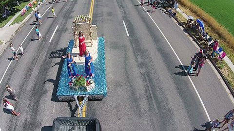 FOUNTAIN GREEN, UTAH - JUL 2014:Aerial rural parade Queen and Royalty wave. Small rural community annual celebration, family reunion festival. Homemade floats, tractors, high school bands.