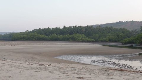 beach with water in the hills and jungles close in the early morning motion