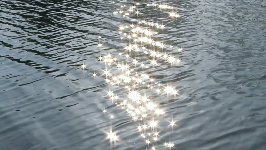 Sunlight reflects and glitters off of the calm water