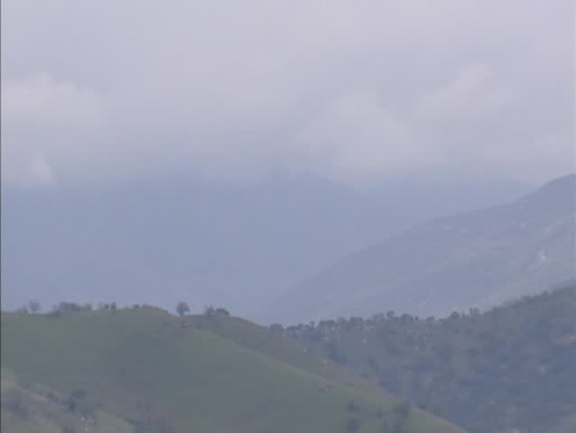 Sierra Nevada  Mountain Range in mist + zoom out valley with Lake Kaweah in the southern Sierra Nevada foothills.