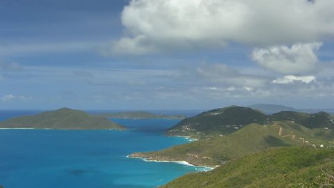 Lovely view to Cooten Bay at British Virgin Islands BVI with nice clouds and some boats (pan)