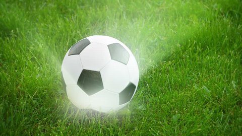 Video 3840x2160 - Soccer ball spinning on the field with rays of light
