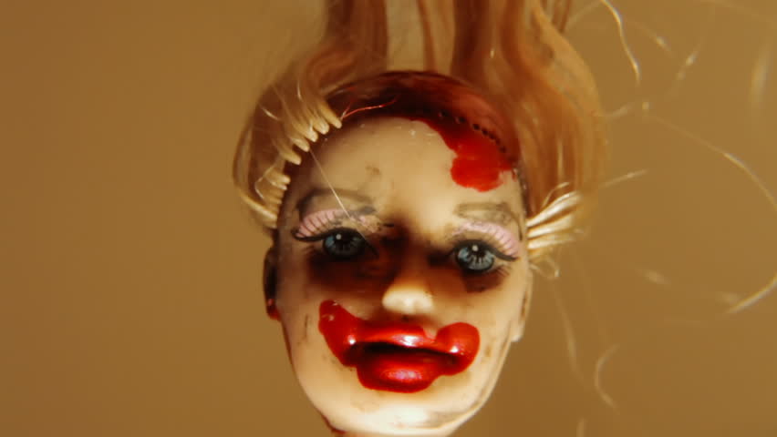 Close-up shot of a cursed doll.
