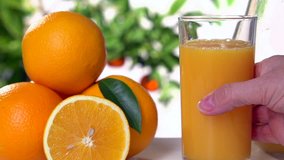 female hand picks up a glass of orange juice. slow motion
,