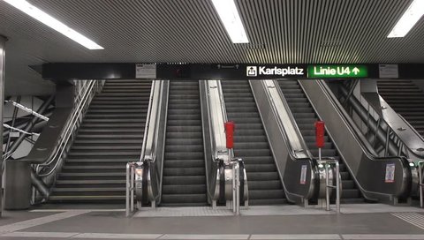 Empty escalator going up and down and usual staircase at metro station Karlsplatz (green line U4),Vienna,Austria