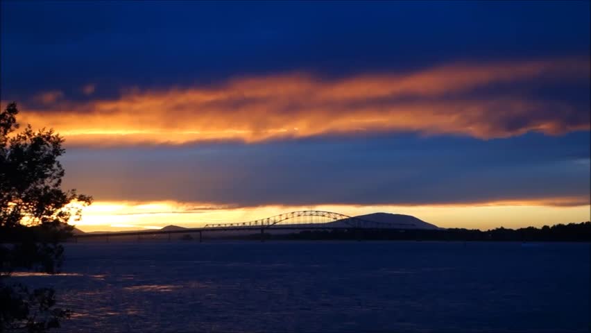 Sunset on river with bridge