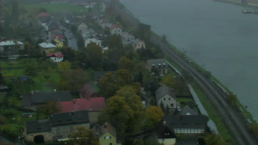 Train passing through village by river