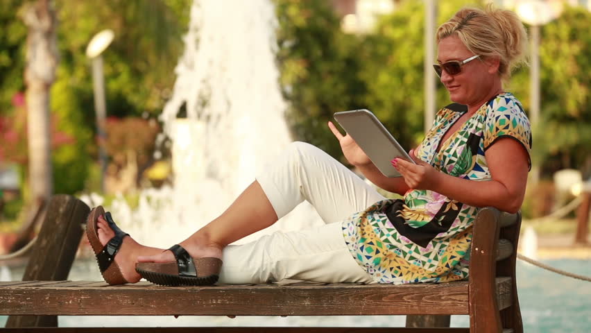 attractive blonde women taking self portrait in the park