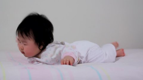 Beautiful Tiny Asian Baby Infant Propping Self up from Side