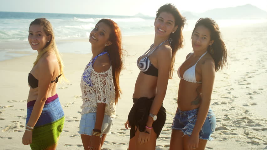 Young beautiful women smile on a beach  | Shutterstock HD Video #7200913