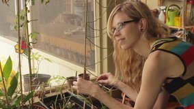 Cute Tattoo Blonde Girl with Glasses in Garden Tending Plants Med - Powered by Shutterstock - Get 15% off with code: PIKWIZARD15