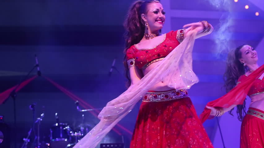 Artist girl dancing on stage in a red national Indian suit