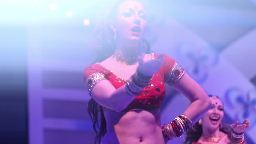 Artist girl dancing on stage in a red national Indian suit